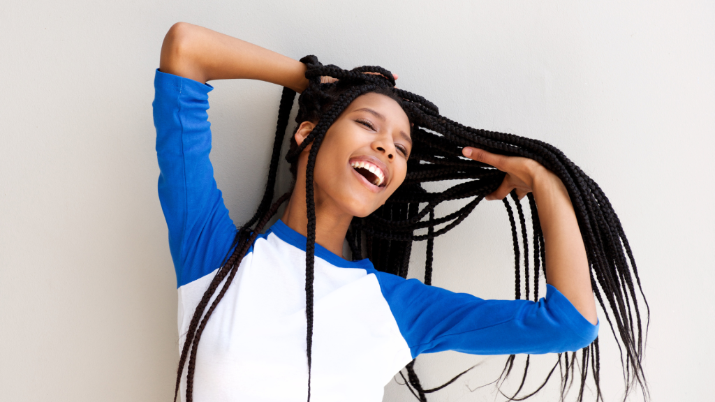 a woman happily wave her braided hair